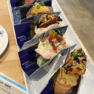 3 regular (eel, rainbow and blue fin) and 2 premium (toro &amp; wagyu uni)