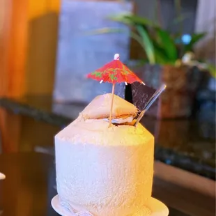 a white cake with a red umbrella on top