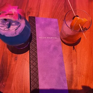 a purple drink and a purple drink on a wooden table