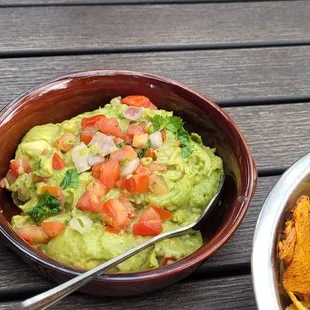 a bowl of guacamole and chips