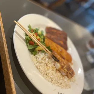 a plate of food with chopsticks