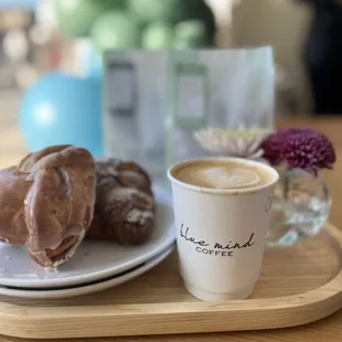 a plate of doughnuts and a cup of coffee