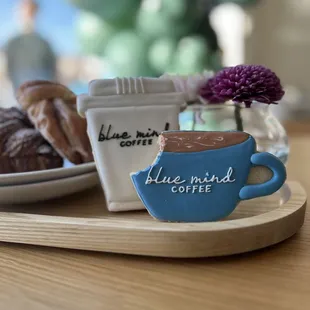 a cup of coffee and a plate of doughnuts