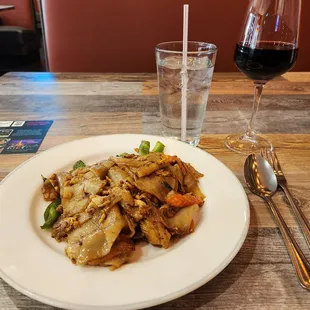 a plate of food and a glass of wine