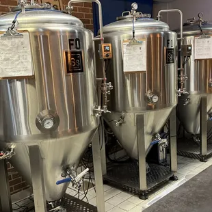 a row of stainless steel tanks