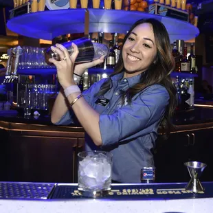 a woman pouring a drink