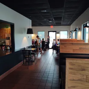 people sitting at tables in a restaurant