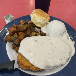 Chicken Fried Steak, mashed potatoes with gravy and fried okra and a biscuit