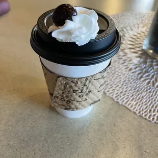 a cup of coffee with whipped cream on top