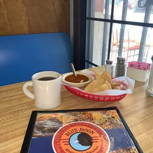 a menu and a cup of coffee