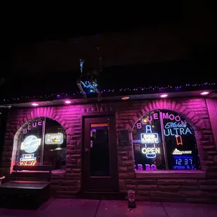 the outside of a restaurant lit up at night