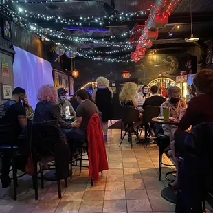 people sitting at tables in a restaurant
