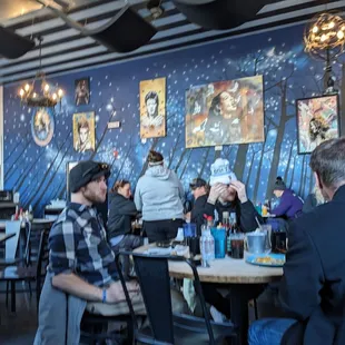 people sitting at tables in a restaurant