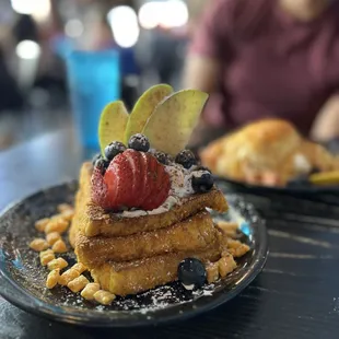 a stack of waffles with fruit on top