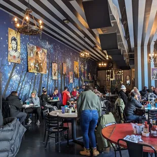 people sitting at tables in a restaurant