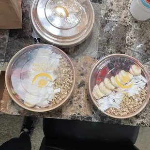 2 açaí bowls with peanut butter in another holder