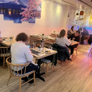 people sitting at tables in a restaurant