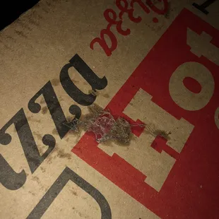 a piece of pizza left on a pizza box