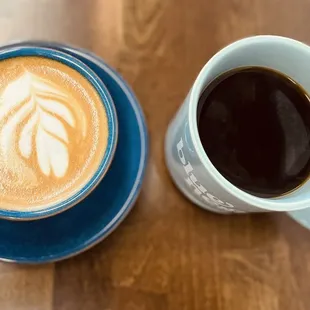 two cups of coffee on a wooden table