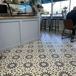 a person sitting at a table in a coffee shop