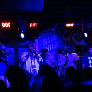 a band performing on stage at night