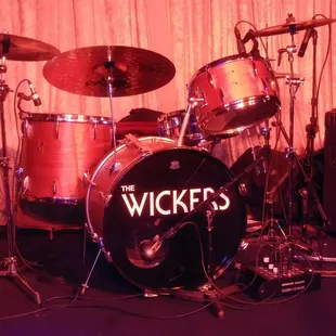 a drum set up in a dimly lit room