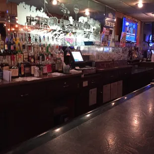 a bar with a lot of bottles of alcohol