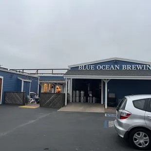 a car parked in front of a blue building