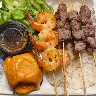 The grilled shrimp and steak kabobs over rice comes with a salad and delicious roll.