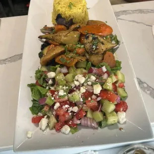 Mixed vegetable platter with saffron rice and Greek salad.