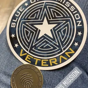 Pictured is a Blue Ops Mission Veteran sticker and, we earned the coin by escaping the room without using all 3 clues!
