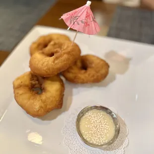 Thai Do-nut with sweet, condensed milk dipping sauce topped with sesame seeds
