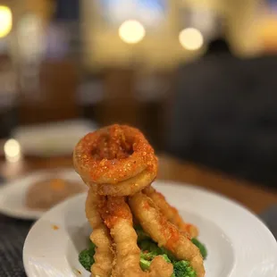 a plate of fried shrimp and broccoli