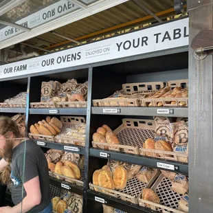 a woman shopping for bread