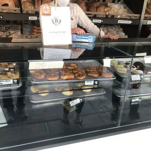 Focaccia, pretzels, sliders, donuts, and scones in front with loaves, English muffins and baguettes behind.