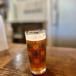 a pint of beer on a wooden table