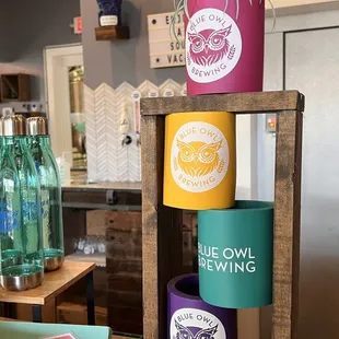 a display of colorful mugs