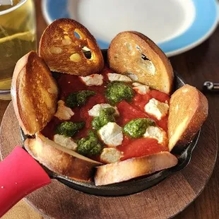 Crostini with marinara, goat cheese, and pesto dip