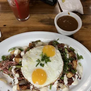 The corn beef hash with the side of brown gravy  must have