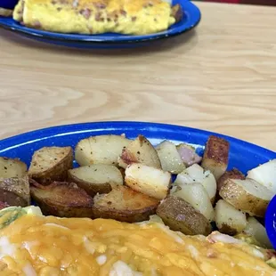 Veggie omelette with home fries, biscuit and gravy and western omelette with fries biscuit and gravy