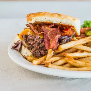 Bacon and cheddar brisket sandwich on our house made brioche bun with fries.