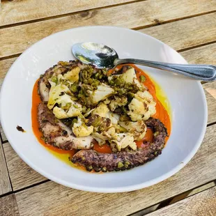 a plate of food on a wooden table