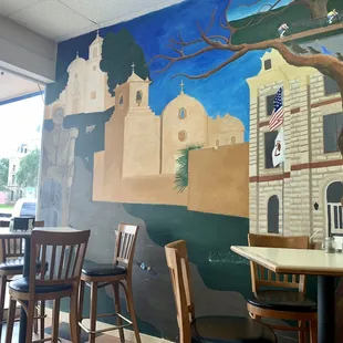 Restaurant interior: mural of historic sites Goliad.