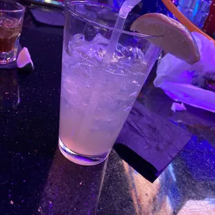 a glass of lemonade with a slice of lemon