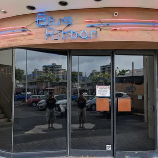 reflection of two people in the window