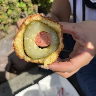 a person holding a hot dog