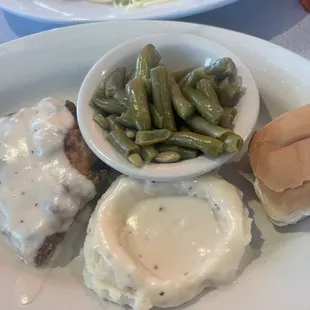 a plate of food with green beans and a sandwich