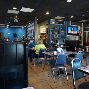 people sitting at tables in a restaurant