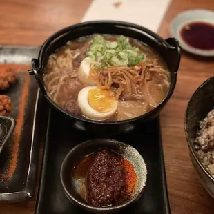 a bowl of ramen, a bowl of noodles, and a bowl of fried