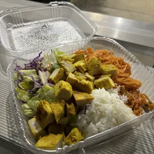 Thai chicken with rice, salad, and noodles